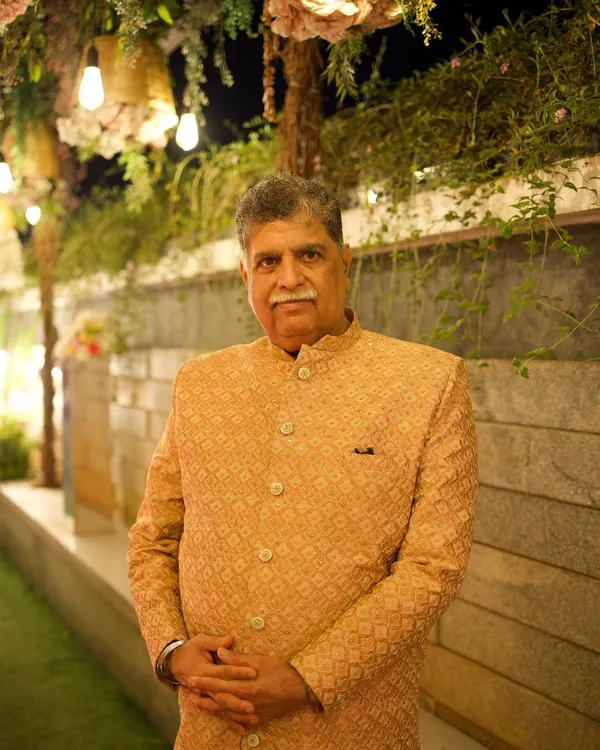 A client looking distinguished and elegant in a golden-beige bandhgala jacket. The subtle pattern and classic cut make this a perfect outfit for the father of the bride or groom, or any guest wanting a regal look.