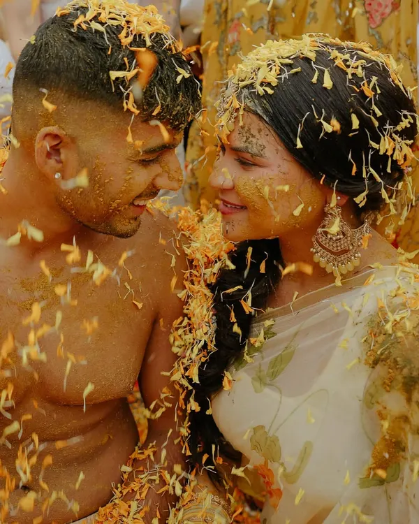 This is the beautiful chaos of a Haldi ceremony. It’s more than just a ritual; it’s an explosion of joy, laughter, and color. This intimate shot of the couple, lost in the moment and covered in petals, shows the fun and authentic energy I love to capture.