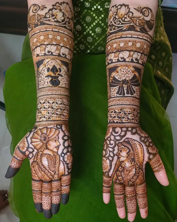 A simple and sweet bridal design with portraits of the couple on the palms. I focused on soft shading for the faces and filled the arms with traditional motifs like elephants and floral bands.