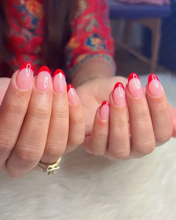 A classic red French manicure is always a good idea. This look features sharp, almond-shaped nails with a sheer pink base and vibrant red tips for a timeless yet bold statement.