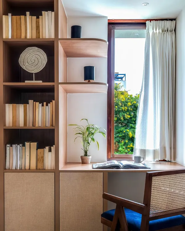 This study area is the perfect spot to dive into your favorite books, with a window that brings the beauty of the outdoors right to your desk. The built-in bookshelf and classic cane chair make it a peaceful corner for introspection and inspiration.