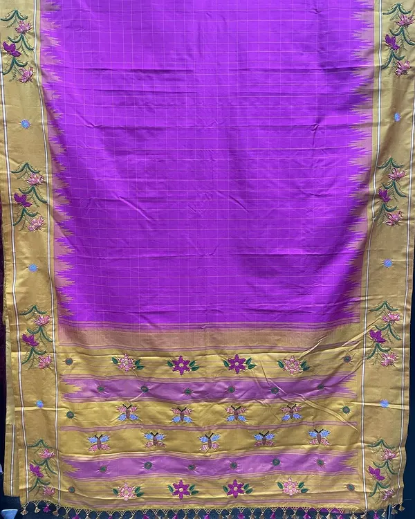 This vibrant magenta Kanjeevaram silk saree was a custom project, brought to life with Kamal Kadai embroidery. The design features floral and butterfly motifs along the golden border, showcasing a traditional weave stitch from Andhra Pradesh and Telangana.