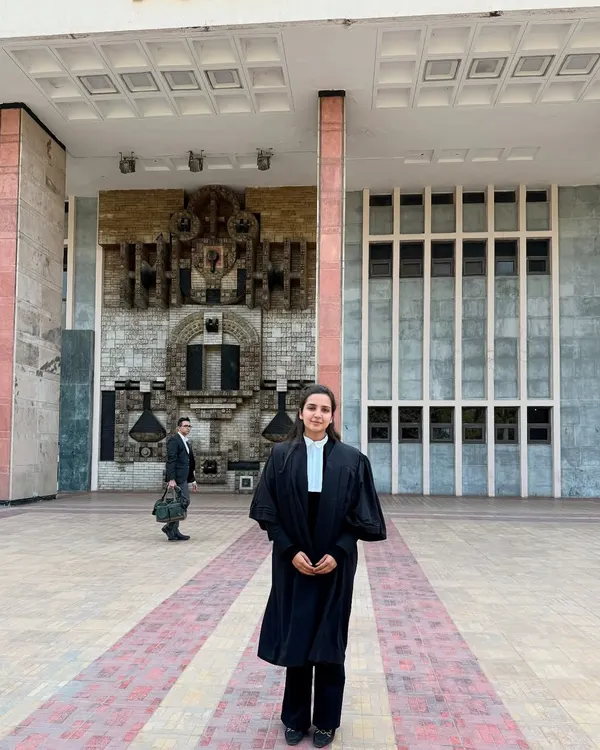 Standing in my advocate's robes outside the Delhi High Court. I am experienced in navigating the procedures and arguing cases within this important jurisdiction.