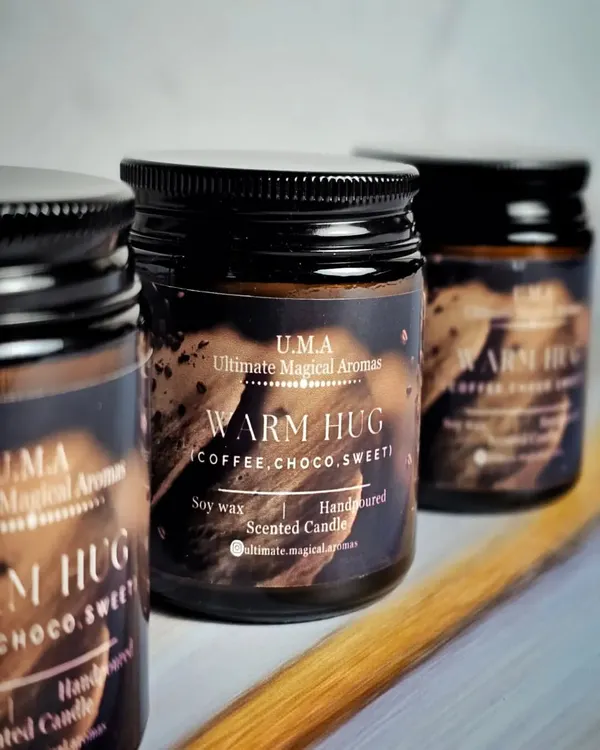 My 'Warm Hug' candle in an amber glass jar, featuring rich notes of coffee and chocolate. This cozy scent is a popular choice for corporate wellness gifts or for creating an inviting atmosphere in cafes and boutiques.