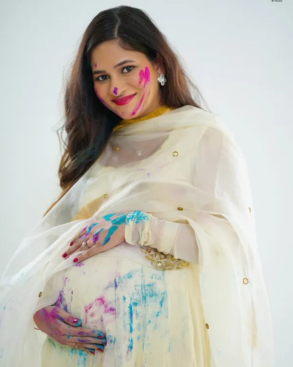 A close-up portrait from our Holi-themed maternity shoot. The bright colors on her face and hands, paired with her joyful smile, perfectly capture the festive and happy spirit of the session.