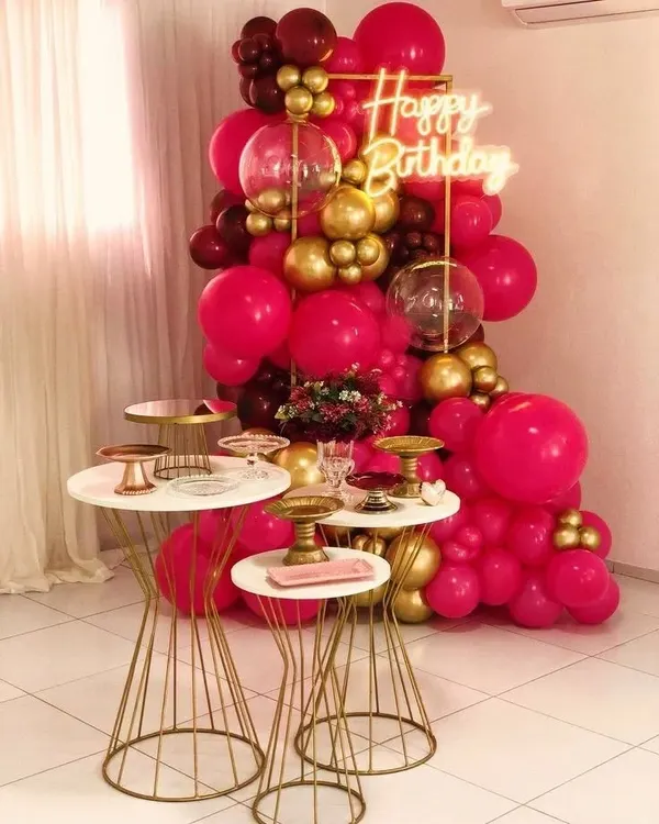 This birthday decor is all about making a bold statement. I used a vibrant mix of hot pink, maroon, and gold balloons to create a rich and energetic backdrop, with a neon sign and modern dessert tables to complete the chic look.