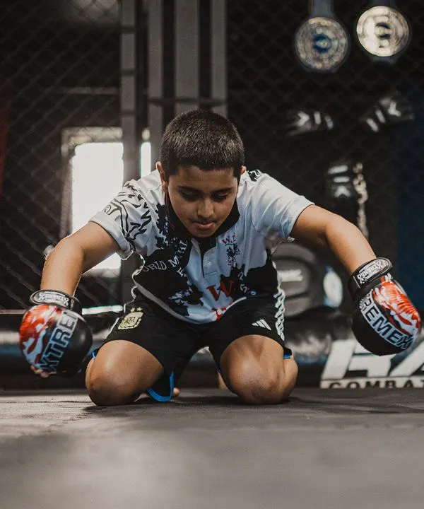 A young warrior performs the Wai Kru, a traditional ritual showing respect to his teachers and the art of Muay Thai. This is where discipline begins.