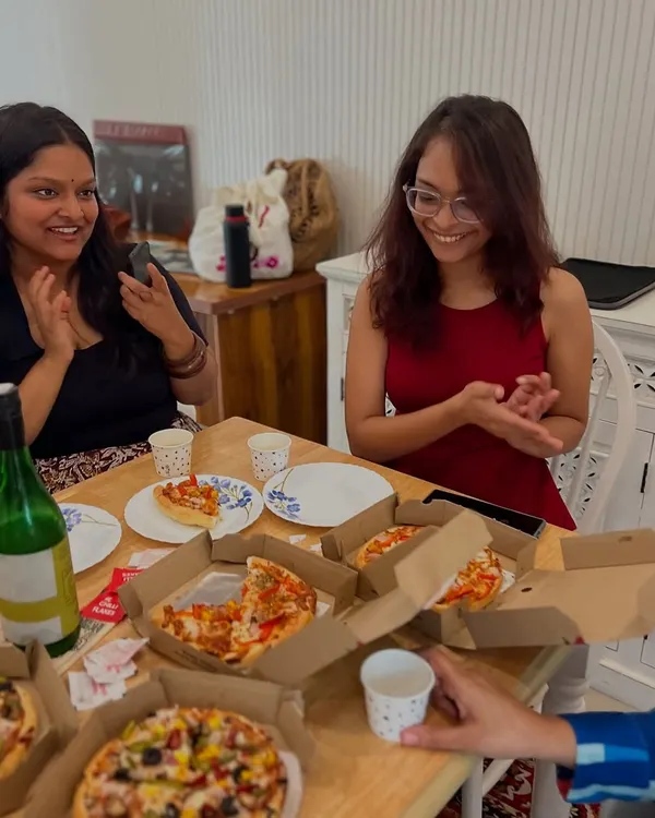 This is what our community looks like. Poets and volunteers sharing pizza and laughter at our studio after a shoot. We believe the best conversations and connections happen over food.