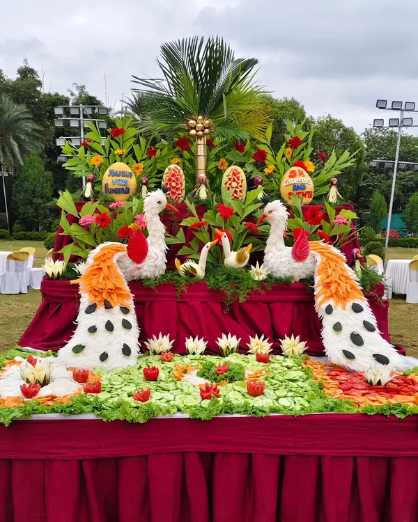 Art you can eat. Our talented team creates stunning displays with vegetable and fruit carvings, like these beautiful peacocks, adding a unique touch to your buffet setup.