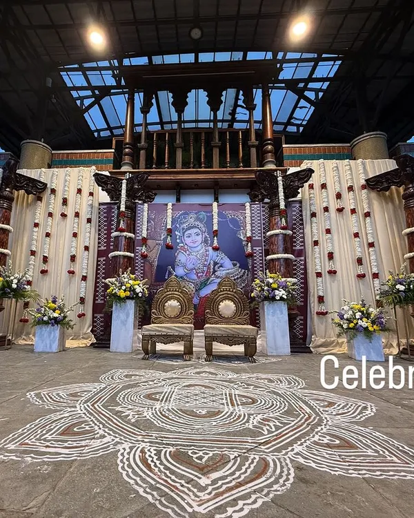 A full view of a traditional baby shower stage. We used majestic pillars, a large Krishna backdrop, and a hand-painted rangoli on the floor to create an authentic and divine atmosphere.