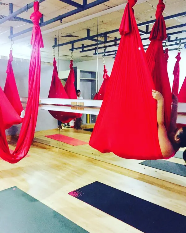 The calm before the storm. Our red silks hanging and waiting for class to begin, ready to support, challenge, and cradle our students.