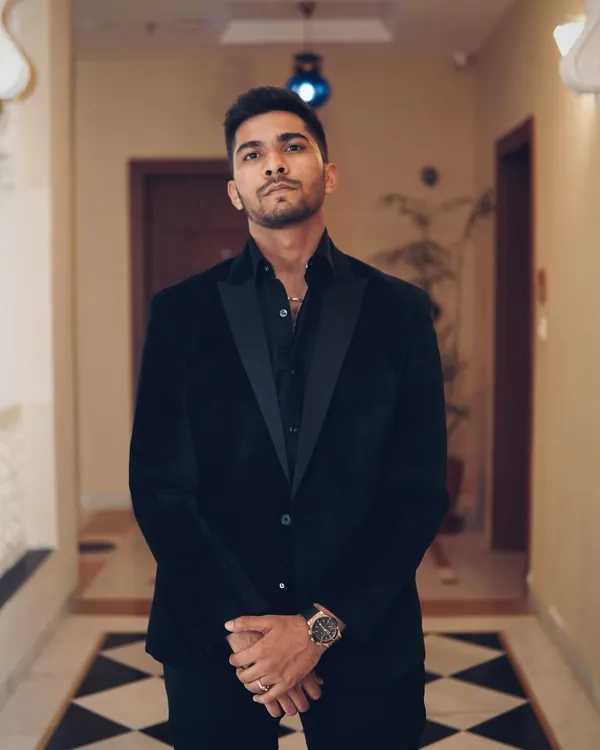 A full-length shot of me dressed in a black suit for a formal event. While I am usually in casual wear, I can dress for any occasion.