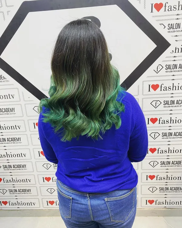 The final result of a creative color transformation. This green balayage with soft waves showcases the skills our students learn in blending, toning, and styling colored hair for a professional finish.