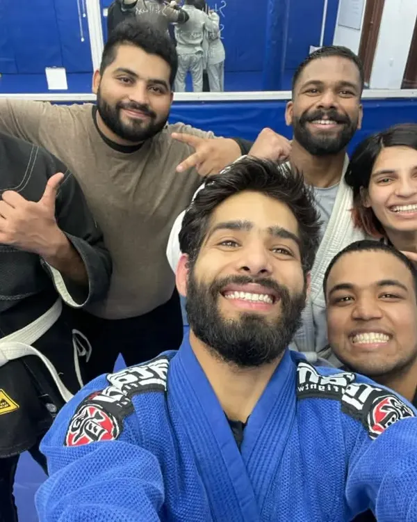 The smiles after a tough roll say it all. This is our BJJ Familia, a diverse group united by a passion for learning and self-improvement.