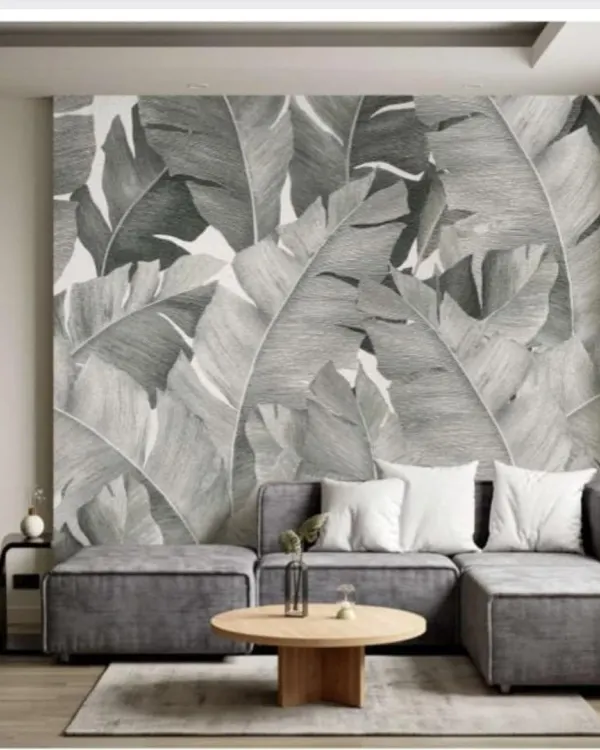 A modern living room featuring a black and white banana leaf wallpaper. This monochromatic design is a stylish and sophisticated way to incorporate a botanical theme.