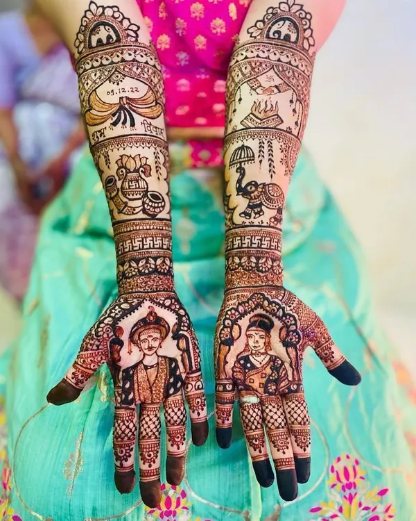This is what I love to do: capture your likeness in intricate henna. This full-coverage bridal mehandi features detailed portraits of the bride and groom, surrounded by traditional wedding motifs like the shehnai and auspicious dates.