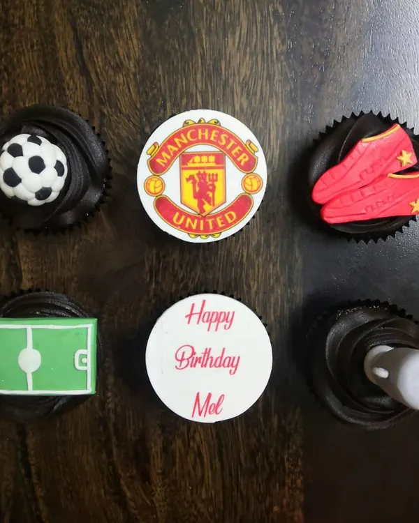 For the ultimate football fan. This Manchester United themed birthday set includes everything from the team crest and a 3D fondant football to edible cleats and a pitch, all on rich chocolate cupcakes.
