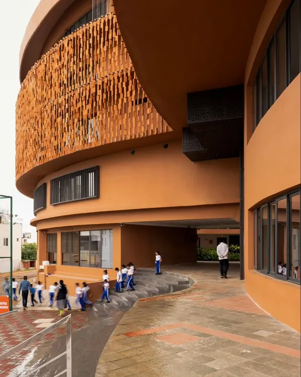 We designed this school in South Bangalore to be a study in form and materiality. The building's fluid geometry and curved terracotta façade create a dynamic yet harmonious presence, demonstrating how institutional architecture can be both monumental and welcoming.