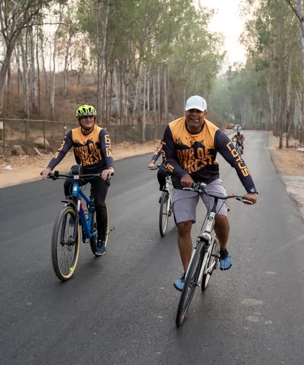 Cyclists enjoying the beautiful, tree-lined roads during our Tour de Forest event. It's a perfect blend of challenging cardio and spectacular scenery.