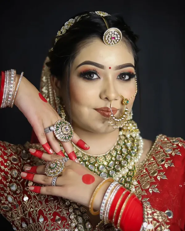 A classic red bridal lehenga paired with soft, glowing makeup. Our students learn to balance tradition with modern techniques for a look that feels both regal and fresh.