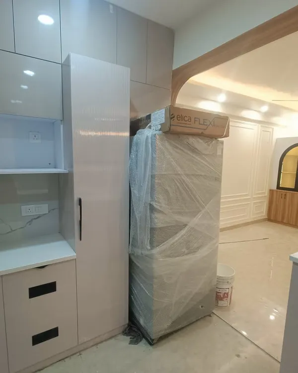 A glimpse of our 3BHK interior project at ATS Rhapsody during the final stages. You can see the newly installed kitchen cabinets and the fridge waiting to be placed.