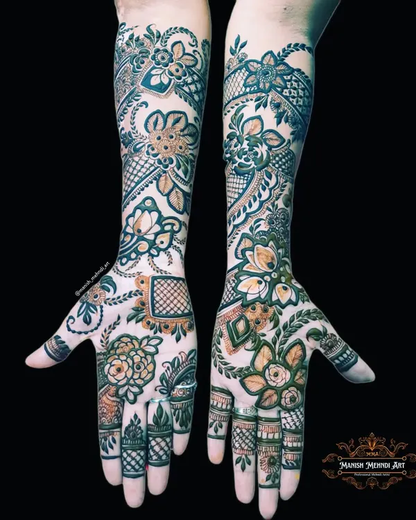 A full bridal mehndi design covering both hands and extending up the arms. The patterns are symmetrical and filled with traditional motifs, creating a rich and classic look for the bride.