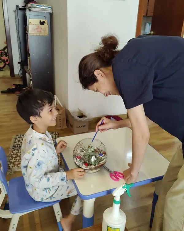 A beautiful moment of parent-child bonding during a terrarium making session. These workshops are a great way for families to connect and create something together.