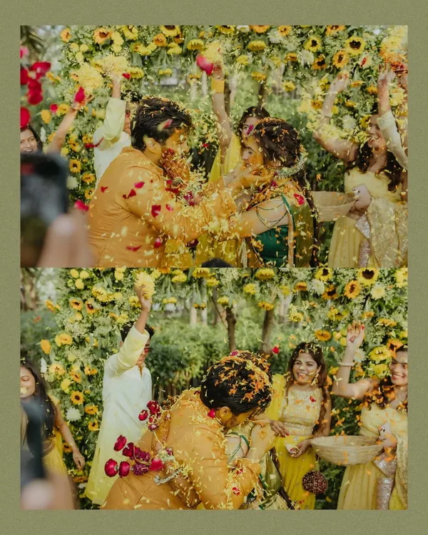 Pure, unadulterated joy as friends and family shower the couple with flower petals during their outdoor Haldi ceremony.
