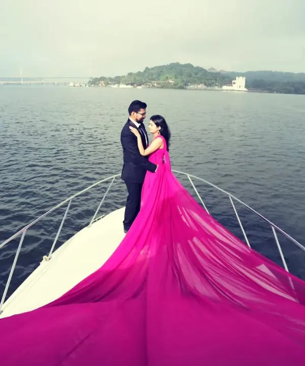 The ultimate fairytale pre-wedding shoot comes to life on a private yacht. This hot pink trail gown is designed for maximum impact, creating a vibrant and unforgettable image that you will cherish forever.