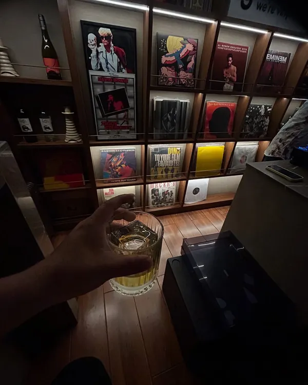 A quiet moment with my vinyl collection. A good drink, and a wall of records featuring artists like Eminem and David Bowie. This is my sanctuary.