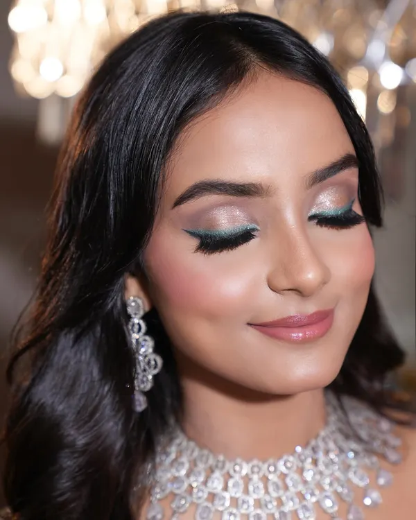 This is one of my favorite ways to make a look pop on camera. I created this sharp, emerald winged liner and paired it with soft, shimmery lids to create a perfect balance of softness and statement. This kind of detailed eye makeup photographs beautifully for fashion and beauty editorials.