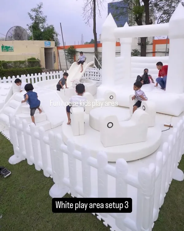Our chic all-white play area is a favorite for birthdays and special events. This outdoor setup shows the full range of fun, including a bouncy castle, slide, soft rockers, and climbers, all safely enclosed so the little ones can play freely while parents relax.