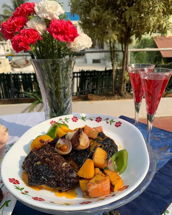 A festive plate of our Roast Xmas Pork Rack, served with roasted vegetables. This dish is perfect for holiday gatherings and showcases a beautifully cooked piece of pork with a rich, flavorful crust.