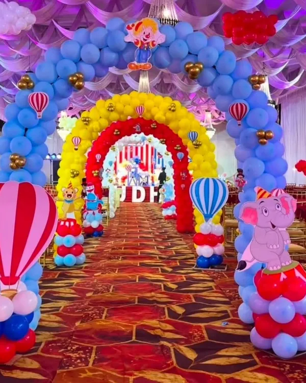 We create immersive experiences like this grand Carnival theme entrance, designed with multiple balloon arches in vibrant primary colors to welcome guests into a world of fun.