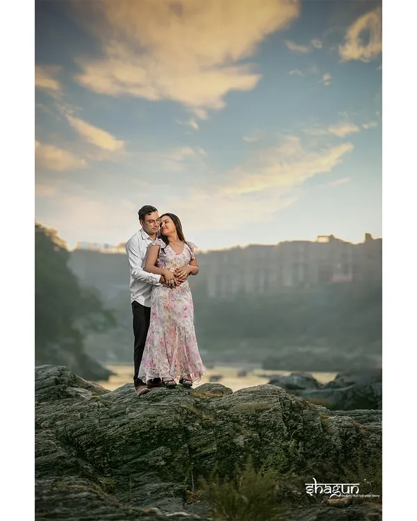 Standing on a cliff, wrapped in each other's arms as the sun sets over Rishikesh. This is the kind of epic, breathtaking shot that you'll want to frame on your wall.