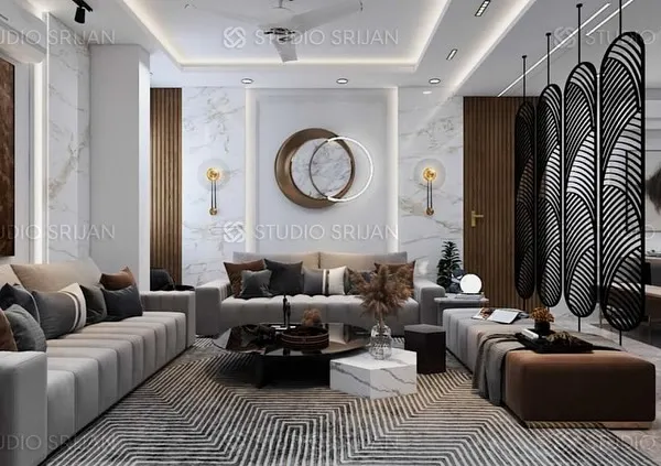 A luxurious drawing room at Rajasthali Apartments, featuring plush sofas, a geometric-patterned rug, and a sculptural screen that elegantly separates the living and dining areas.