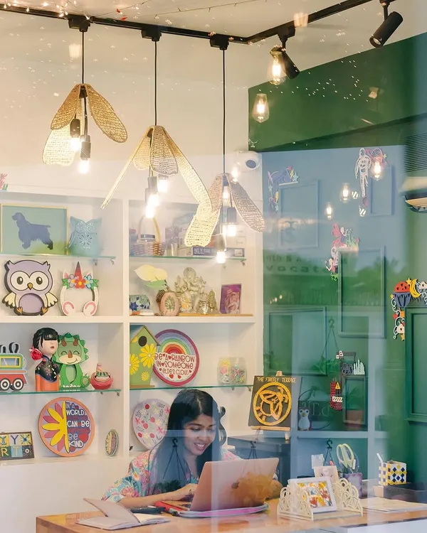 A glimpse into the studio from the outside. I wanted to create a space that looks as magical as it feels, with warm lights and shelves filled with colorful art projects that spark your curiosity before you even step inside.