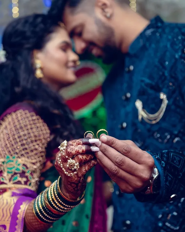 A close-up shot focusing on the couple's hands as they hold their engagement rings, a symbol of their commitment.