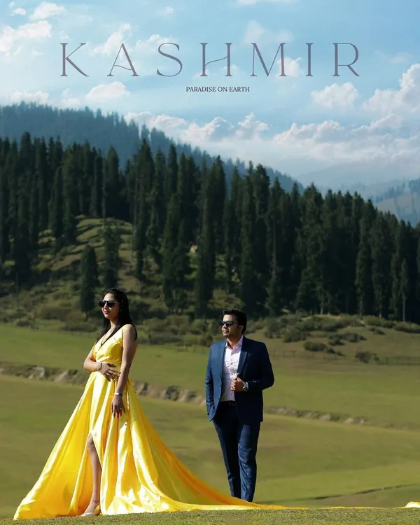 A breathtaking moment in Kashmir, where the vibrant yellow of a flowing gown contrasts beautifully with the lush green meadows and pine forests. This is the kind of epic, cinematic shot that turns your love story into a work of art. This is what I mean by destination pre-wedding photography.