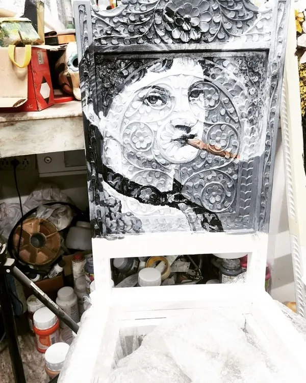 Here's another example of our custom chair painting service. This piece features a monochrome portrait in a classic style, showing how we can adapt our art to different aesthetic preferences, even on complex carved surfaces.