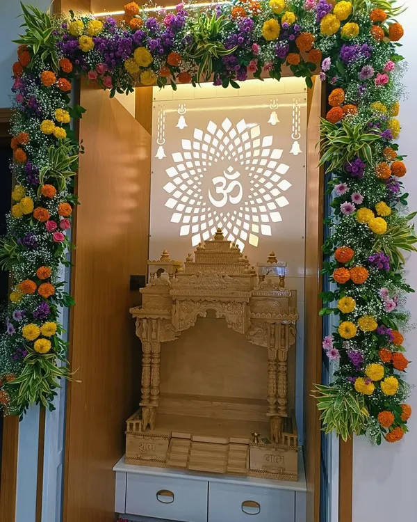 We decorated this beautiful home mandir with a full floral arch made of bright marigolds, purple statice, and baby's breath. The design complements the intricate wooden temple and the backlit 'Om' panel, creating a truly divine prayer space.