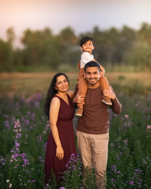 A beautiful family of three, surrounded by a field of purple flowers. This portrait captures the love and happiness of this family, a memory created from a moment of being truly present with each other.