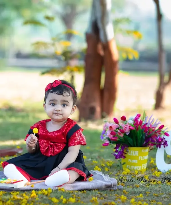 Celebrating the big 'One'. This outdoor first birthday shoot is set against a beautiful park backdrop, using simple props to keep the focus on the birthday girl's sweet and curious nature.