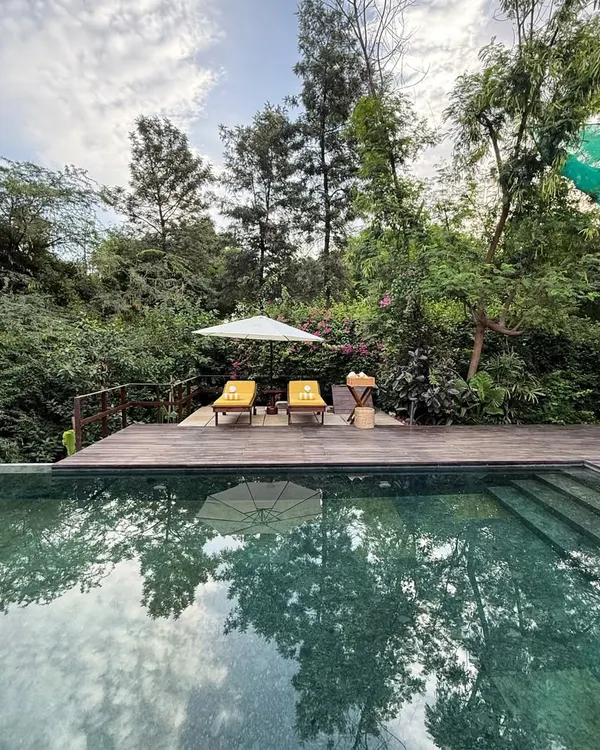 This is the heart of our sanctuary. The infinity pool, bordered by the Asola Biosphere, reflects the sky and trees, offering a space for quiet contemplation and a refreshing escape from the city.