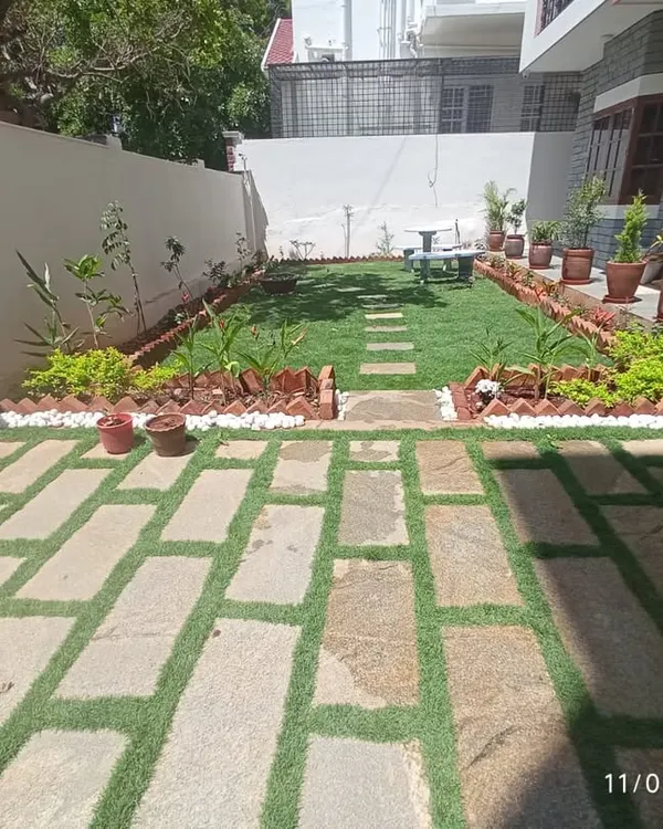 A complete front yard makeover. We installed a lush lawn, a stone pathway, and perimeter garden beds, creating a structured and inviting entrance to the home.