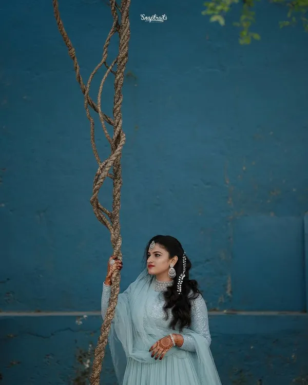 I loved this shot of the beautiful bride Hamnaz. The contrast between her soft blue anarkali and the bold blue wall created a striking visual, making for a truly artistic bridal portrait that feels both timeless and modern.