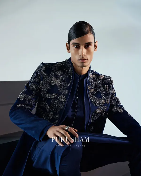 This is the embodiment of my design philosophy. A bespoke velvet jacket in deep navy, brought to life with intricate hand-embroidery that catches the light. It's a garment designed not just to be worn, but to be felt, projecting confidence and a regal presence.
