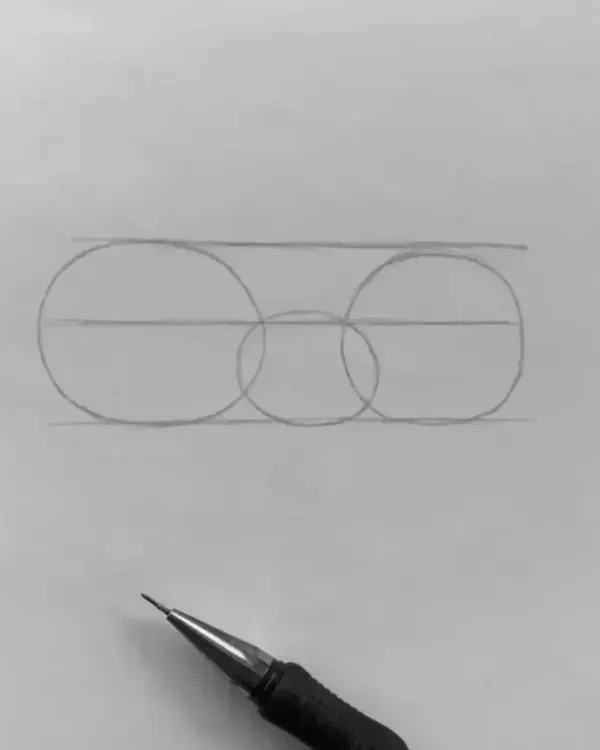 Step 1: A tutorial on how to structure a face for a portrait. I start with basic circles to map out the placement of the eyes and nose, creating a solid foundation.
