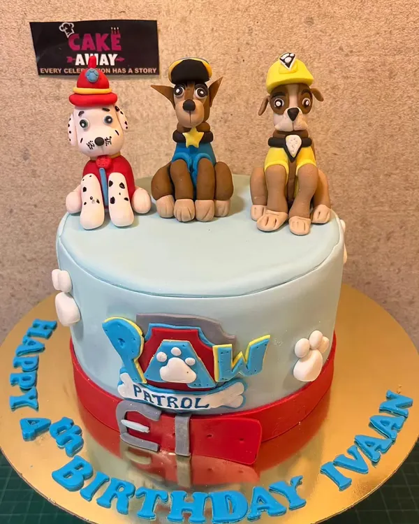 A Paw Patrol cake ready for action. This design features hand-molded, edible figurines of Chase, Marshall, and Rubble on top of a fondant-covered cake.