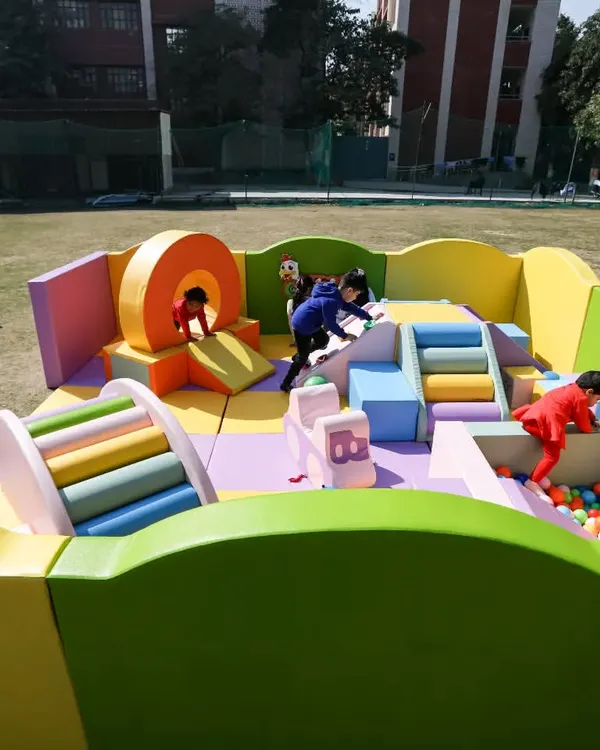 A full view of our colorful soft play area, set up and ready for fun in a spacious outdoor setting. It's a safe and exciting world for kids to explore.